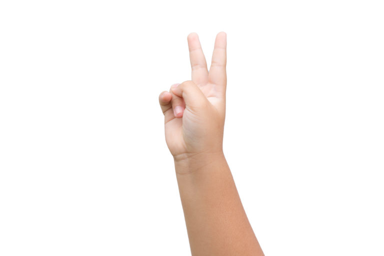 Boy hand showing two fingers as victory sign on white background