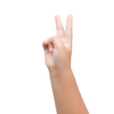 Boy hand showing two fingers as victory sign on white background